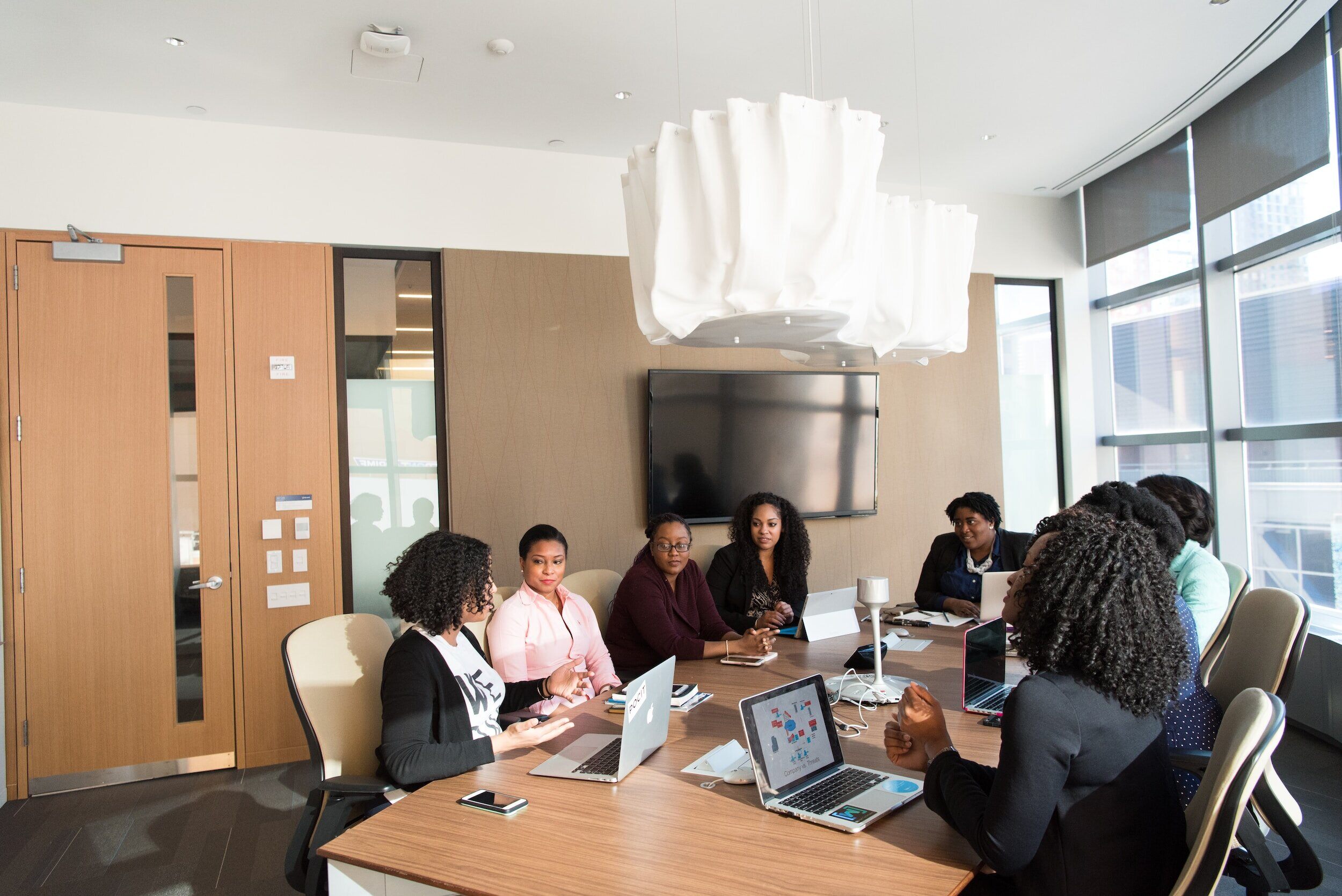 People around a desk in an office space